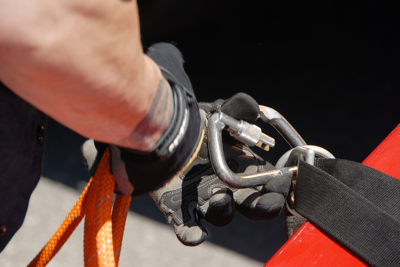 Worker adjusting lanyard.