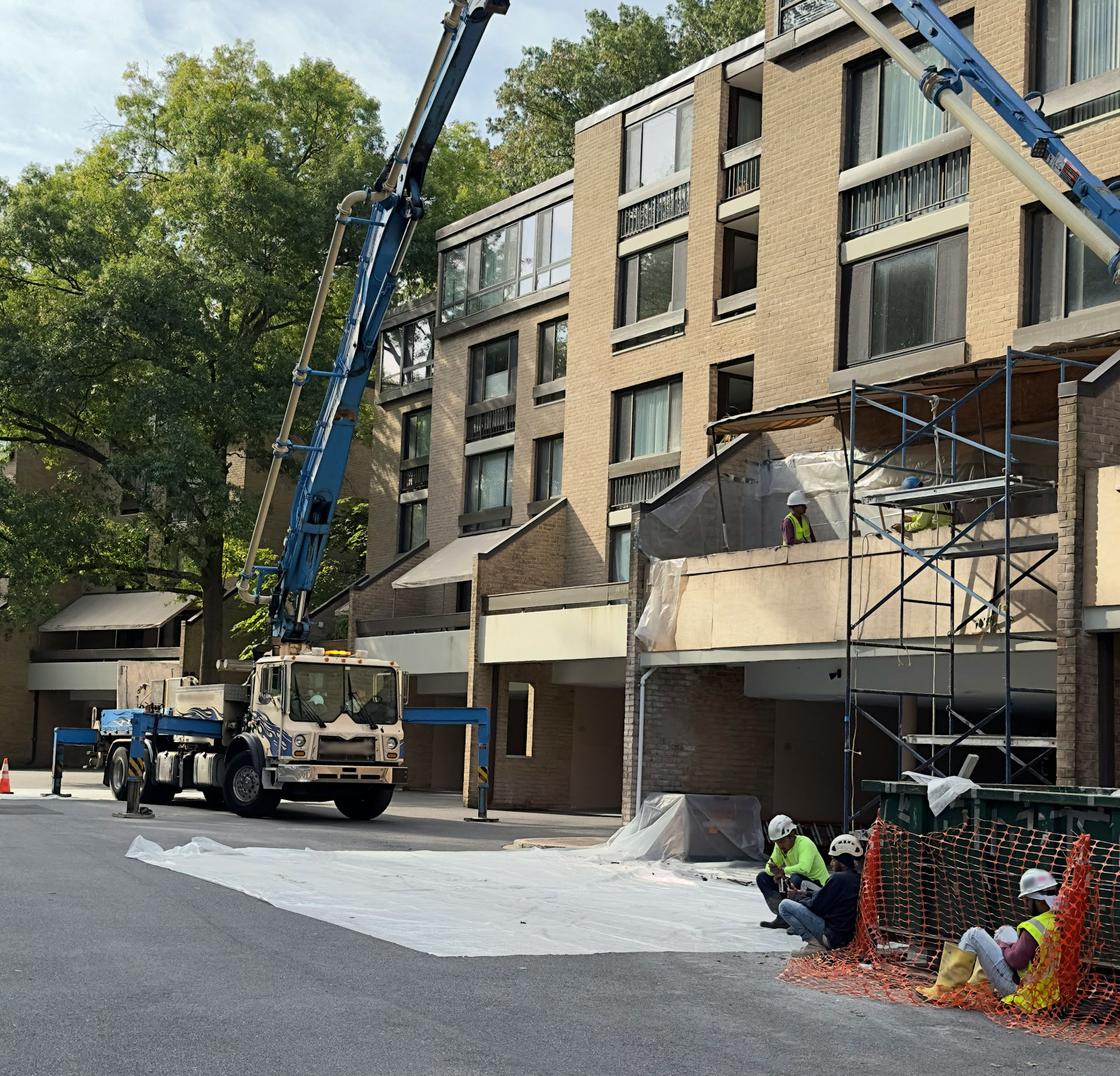 Construction workers taking a break in front of a building.