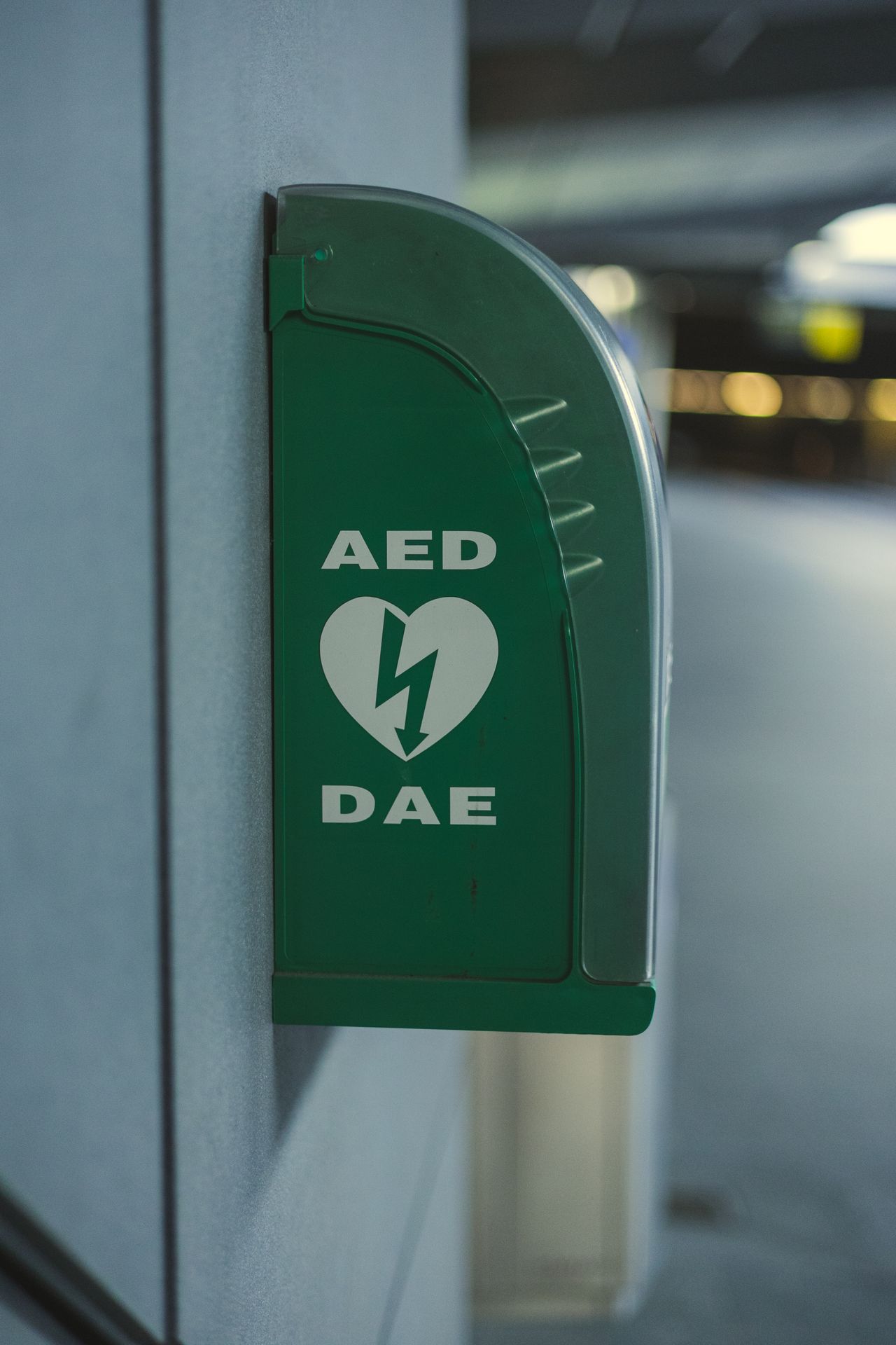 green AED device on wall