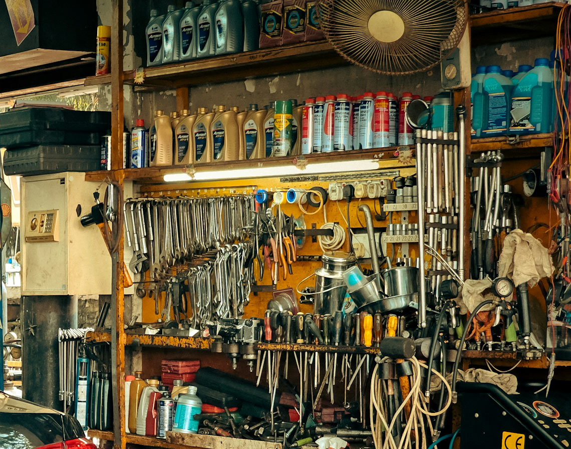 Garage shelves stacked with tools and chemicals