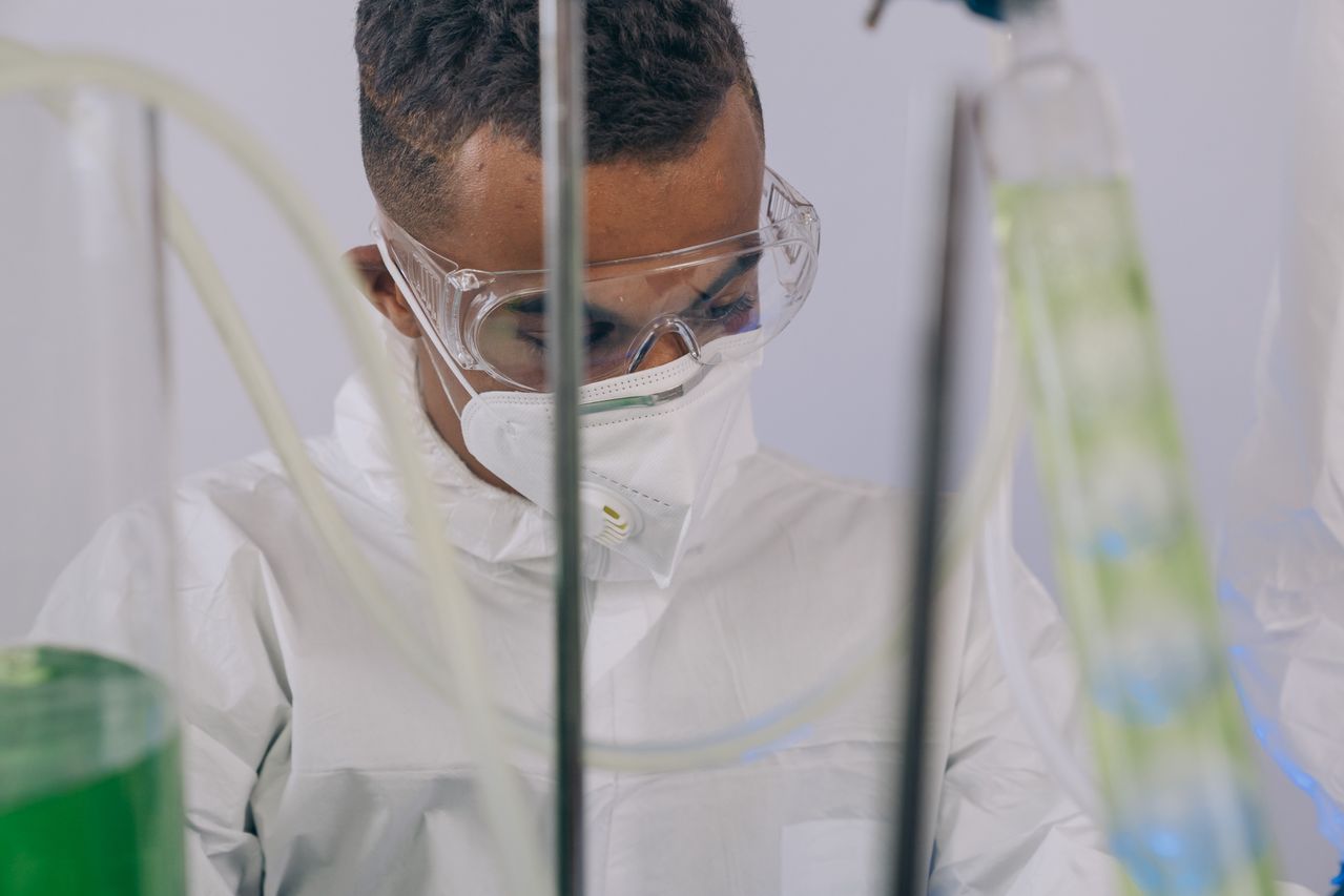 chemist in lab wearing PPE