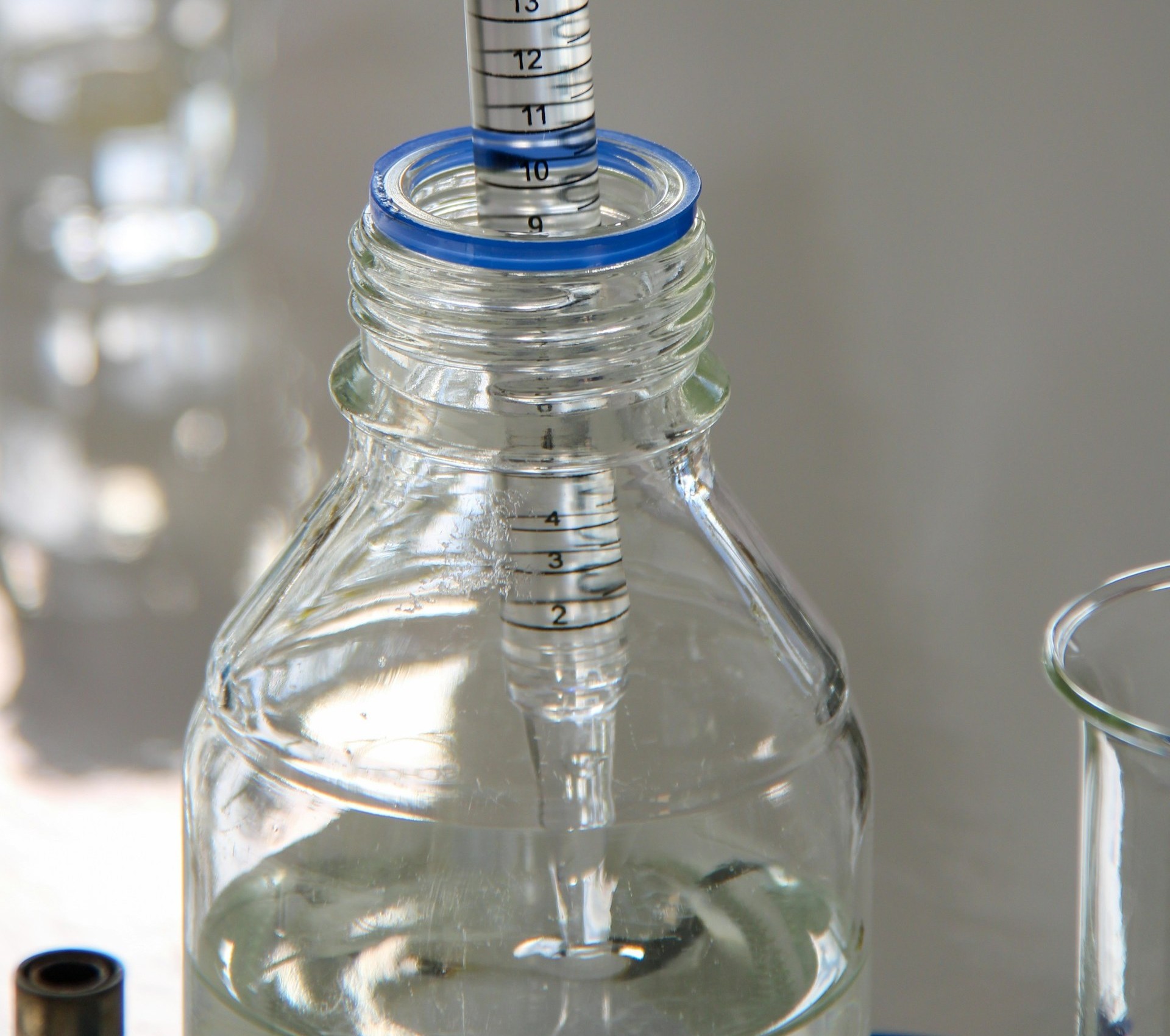 pipette dispensing clear liquid into a bottle